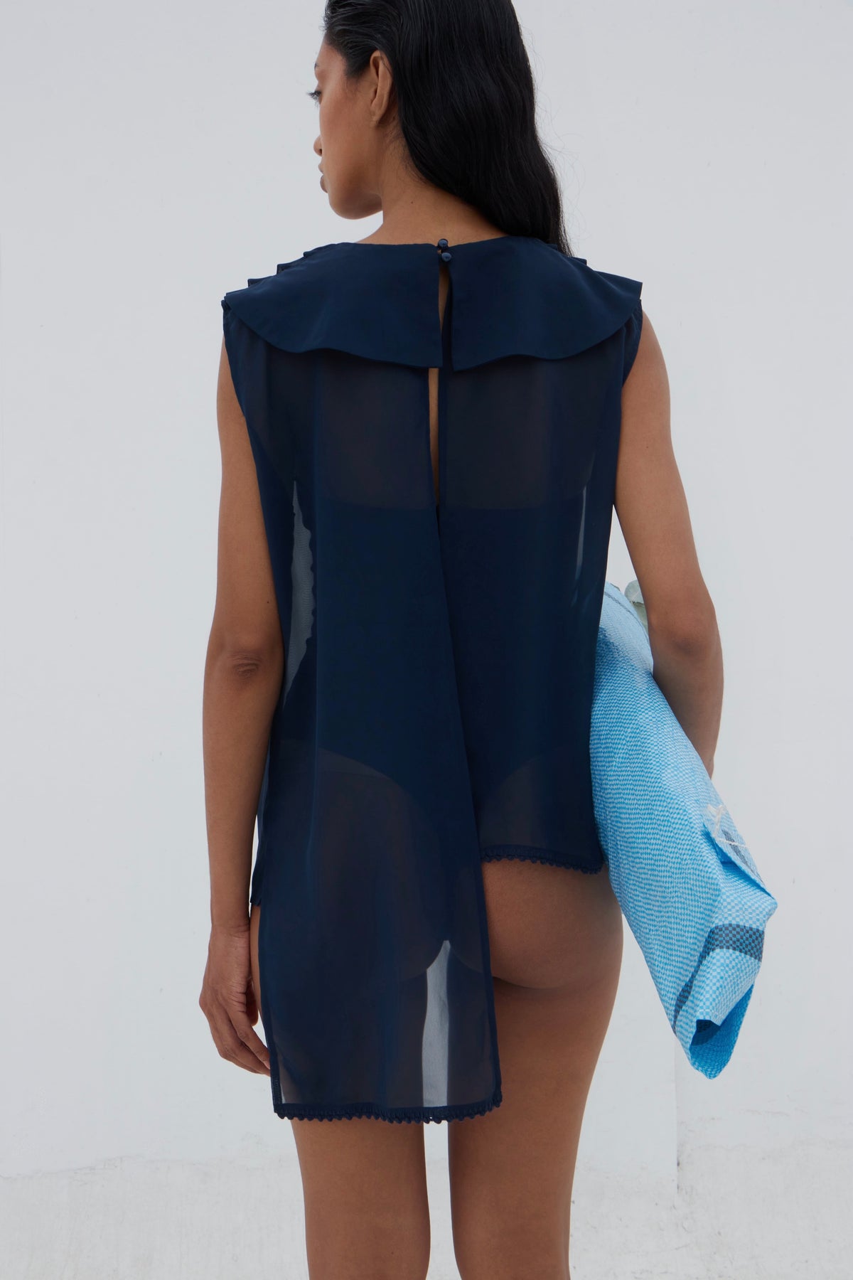 Yaku sheer blouse styled on model, three-quarter view